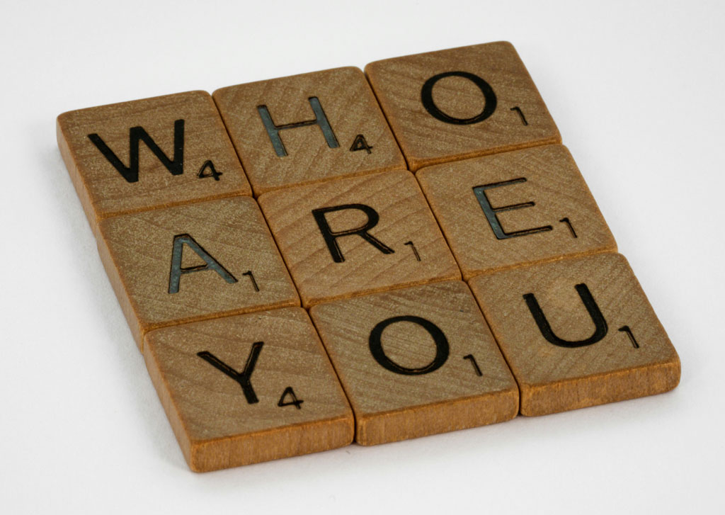 Wooden letter tiles spell out the words Who Are You